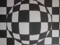 Efektowna kula z czarno-białej szachownicy, tworząca iluzję głębi. Proste, ale efektowne op art.