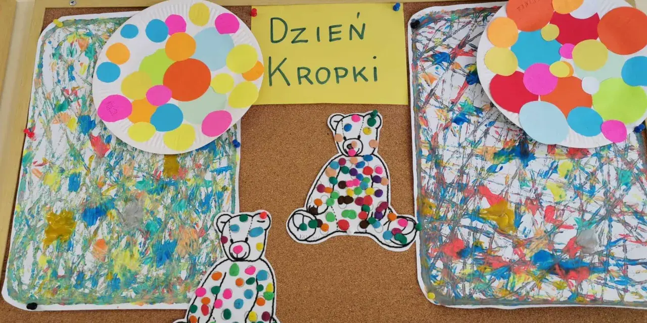 Kolorowe misie i talerze ozdobione kropkami na tablicy. Dzieci tworzyły wspaniałą pracę z kropek, celebrując Dzień Kropki.