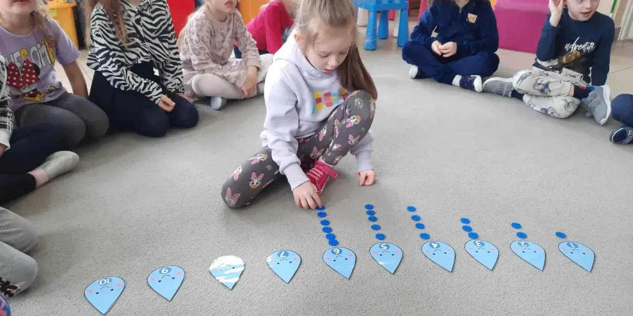Dzieci uczą się liczyć z kroplami wody. Wspaniałe dzień wody pomysły na edukacyjną zabawę.