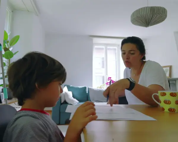 Mama uczy syna literki "g". Dziecko z uwagą słucha, a mama pokazuje mu ćwiczenia.