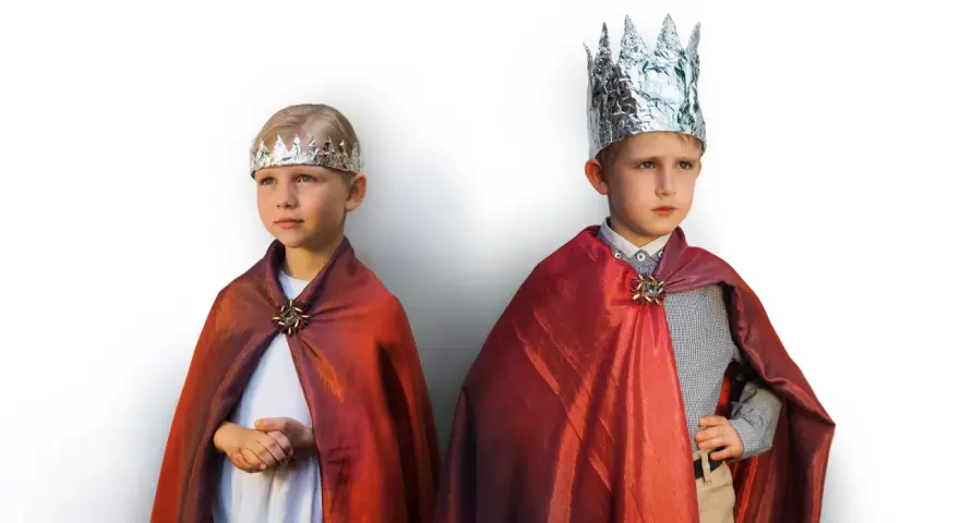 Dwóch chłopców w błyszczących płaszczach i koronach z folii aluminiowej. Inspiracja, jak zrobić strój na bal wszystkich świętych.